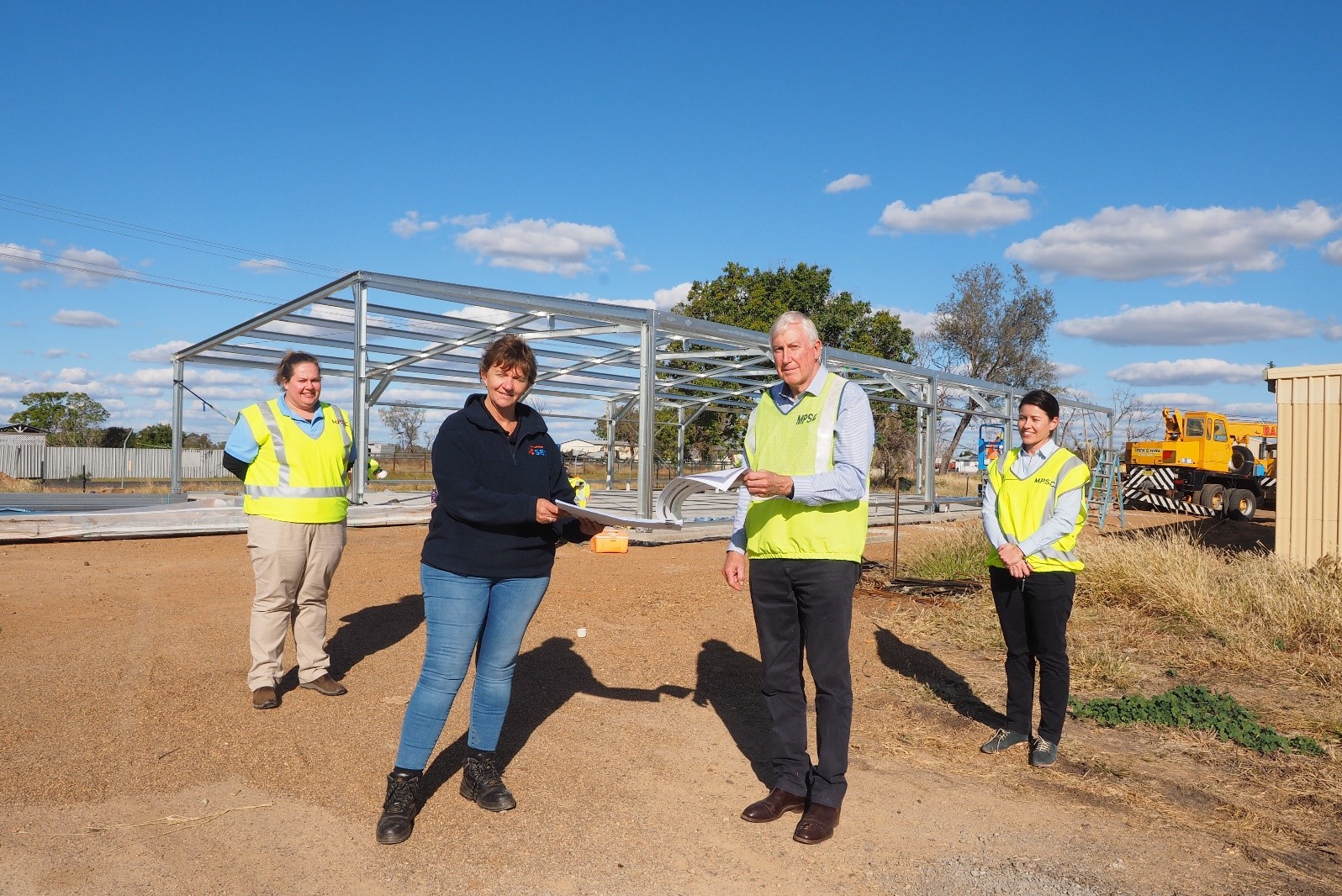 Photograph 1 caption: Moree Plains Shire Council LEMO Renee McMillan, More Unit Commander Vivianne Fouracre, Project Managers Graham MacPherson and Emily Gall inspect the plans for the new unit headquarters in Moree.